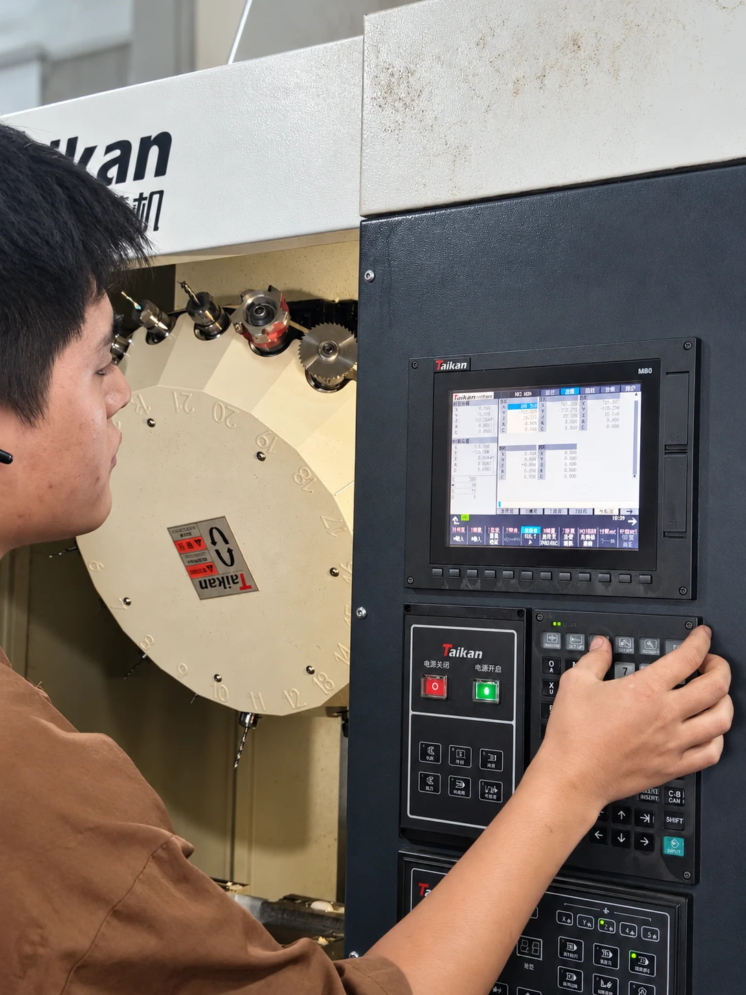 An operator adjusting settings at the machine